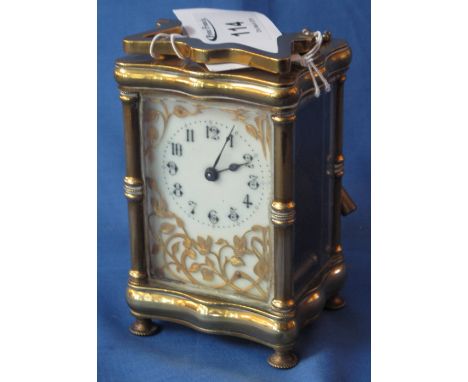 French brass carriage clock having serpentine gorge type case and full depth enamel face with gilded filigree work.  CONDITIO