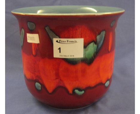 Poole pottery straight sided vase or planter with abstract coloured decoration on a red ground. Moulded and painted marks to 