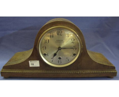 Mid century oak three train hat shaped mantel clock with silvered face marked Morcom, Carmarthen. 