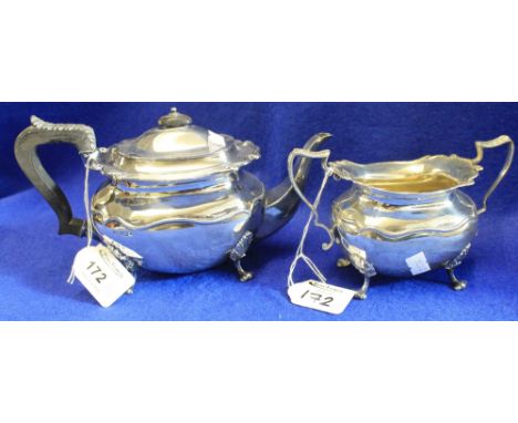 Silver teapot with scrolled border and raised on four scroll feet, Sheffield hallmarks, maker's marks: J.R. together with mat