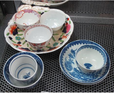 Two New Hall type porcelain tea bowls, another similar, a first period Worcester blue and white tea bowl with two saucers fis