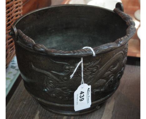 Chinese bronze, bucket shaped censer with relief dragon decoration and swing handle.
