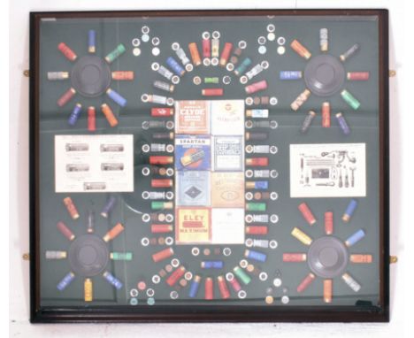 A large contemporary shotgun shell display case. The case of deep-set form having a series of well-displayed shotgun shell ca