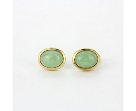 A pair of 9ct yellow gold stud earrings set with polished nephrite jade, L. 1cm.