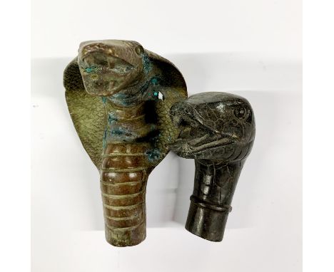 Two bronze snake head walking stick handles, largest L. 10cm.