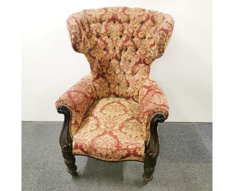 An early 20thC wingback armchair with button back upholstery on a carved mahogany frame, H. 115cm W. 68cm.