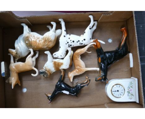 A Collection of un marked ceramic figures of dogs to include greyhound, Dalmatian, St Bernard, Chinchilla , Rough Collie and 