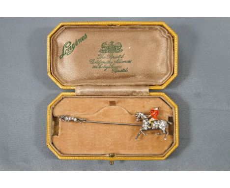 A yellow and white metal bar brooch depicting a horse and fox each set with single and rose cut diamonds and finished with en