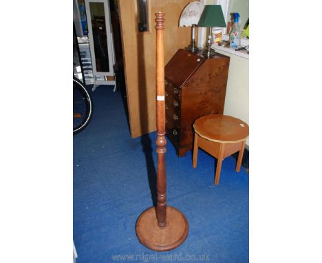 A turned wooden standard lamp column.