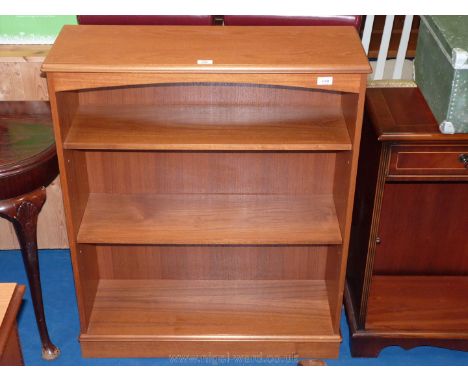 A three shelf pine bookcase.