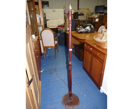 A wooden standard lamp.