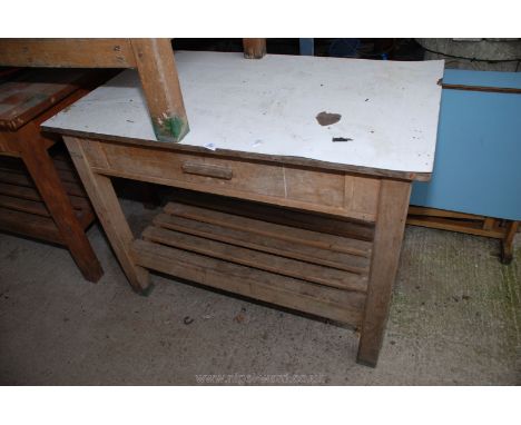 A melamine topped pine work bench with drawer and under shelf. 34" x 45" x 27".