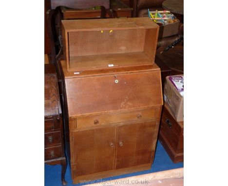 A light oak writing bureau with storage shelves.