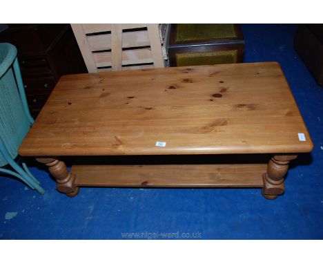 A modern pine coffee table with solid under shelf. 48" x 23 1/2" x 18" high.