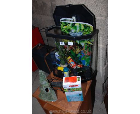 A fish tank with water pump, light filter and accessories. 15" high x 16" long x 8" deep.