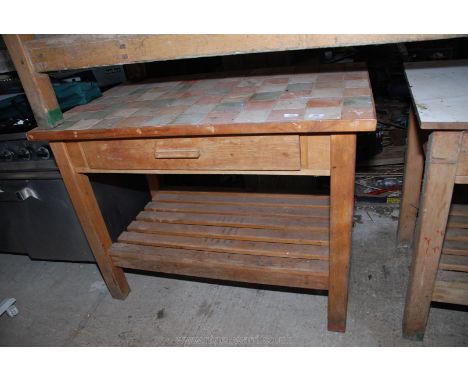 A tiled topped pine work bench with drawer and under shelf 34" x 45" x 27".
