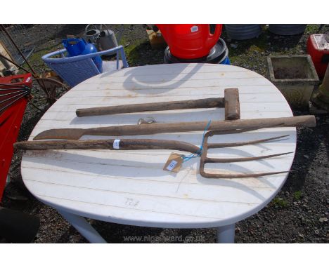 A garden fork, a slasher and a sledge hammer