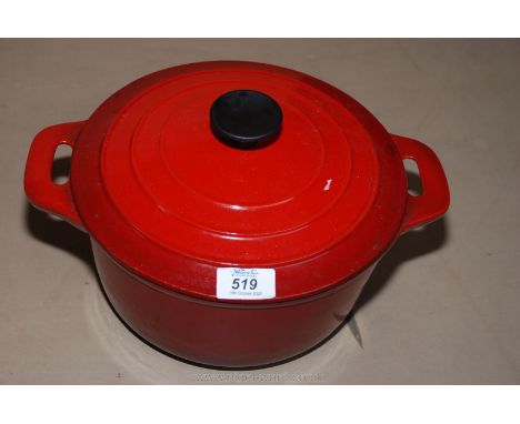 A red enamel casserole Dish. 9 1/2" diameter.