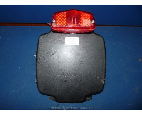 A new "old stock" rear number plate holder (P.no. 82-3363) and a Luca L564 light for a Truimph motorcycle 500/600 cc, etc.