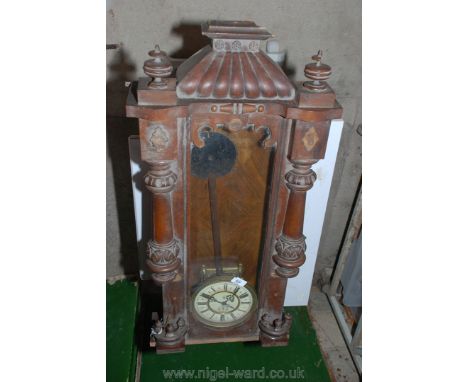 A hardwood wall hanging pendulum clock with enamel face and Roman numerals. A/F.