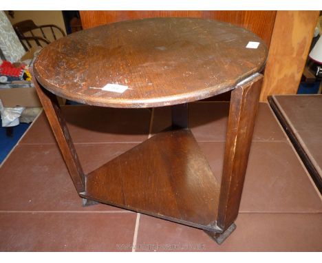 An oak circular top table with triangular under shelf. 20" diameter x 18" high.