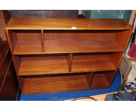 A modern teak style three shelf bookcase/display unit. 48" long x 10" deep x 38" high.
