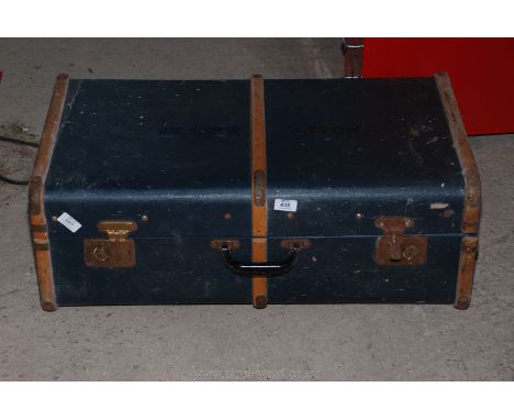 A bent wood bound travel trunk.