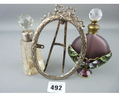 Butterfly decorated scent bottle and one other with a hallmarked silver portrait frame