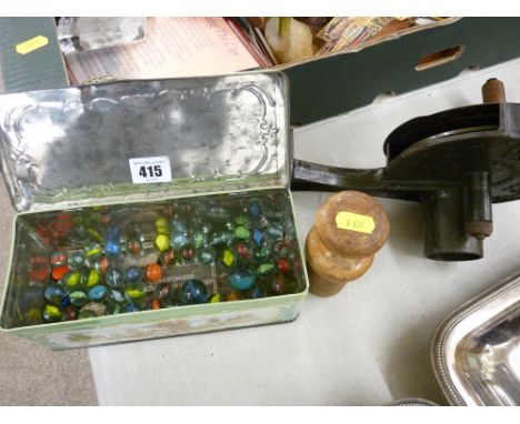 Vintage cast iron marmalade cutter and a tin of vintage marbles