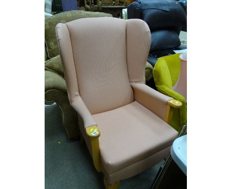 Light wood and pink upholstered wingback armchair