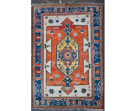 A MID TO LATE 20TH CENTURY TURKISH RED, BLUE AND WHITE GROUND CARPET with geometric decoration, 246cm x 372cm Condition: some