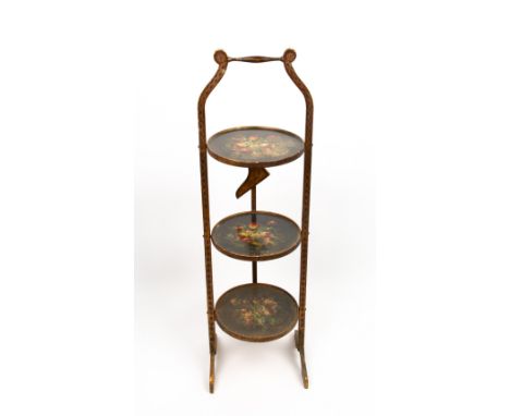 A DECORATIVE EARLY TO MID 20TH CENTURY THREE TIER CAKE STAND with gilt frame and painted floral decoration to the three foldi