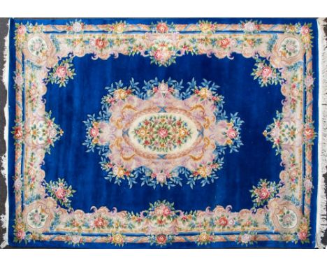 A MID TO LATE 20TH CENTURY CHINESE BLUE GROUND WOOLEN CARPET with stylised floral decoration, 280cm x 275cm  Condition: some 