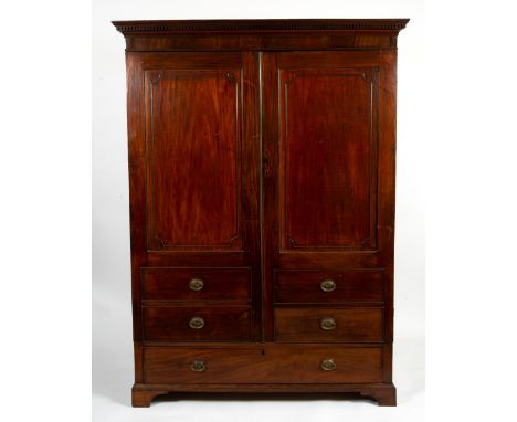 A 19TH CENTURY MAHOGANY WARDROBE possibly originally from Jersey with dentil ornament to the cornice and twin doors enclosing