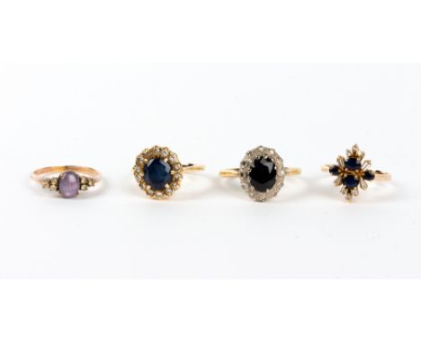 A SAPPHIRE AND WHITE STONE INSET YELLOW METAL CLUSTER RING marked 14K; a sapphire and diamond 18 carat gold ring; a blue and 