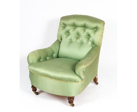 A LATE VICTORIAN GREEN SILK STYLE UPHOLSTERED ARMCHAIR with turned front legs terminating in brass and ceramic casters, 78cm 