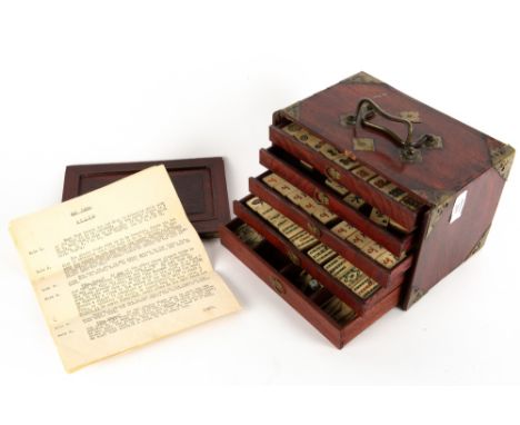 AN EARLY 20TH CENTURY BONE AND BAMBOO MAHJONG SET in a brass and hardwood mounted six drawer chest, 24cm wide x 16cm deep x 1