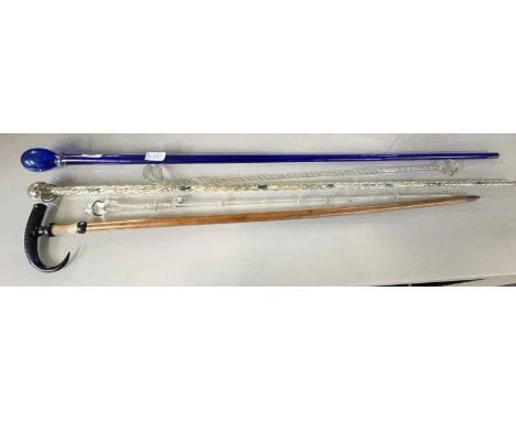 A collection of Victorian novelty glass walking canes comprising a blue glass example, a barley twist example with beadwork c