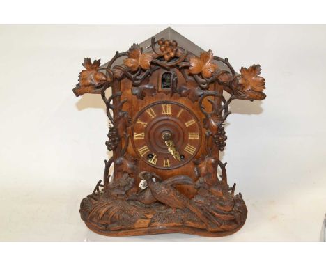 A cuckoo mantel clock with key