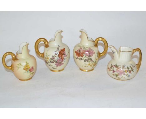 A group of four late 19th/20th Century blush Worcester jugs with gilt handles and floral decoration, factory puce mark to bas