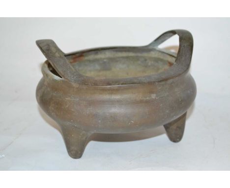 A Chinese bronze bowl raised on three stub feet with six character mark to base, 18cm diameter
