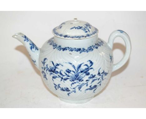 An 18th Century Worcester porcelain teapot, the feather moulded body with blue and white decoration and a cover (non matching