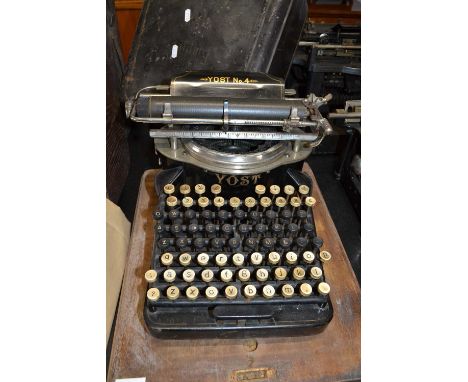 A vintage Yost No 4 typewriter with wooden travel case