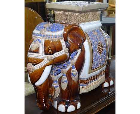 A pair of glazed ceramic elephant seats 