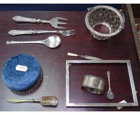 A box containing Georgian silver and mother-of-pearl scoop, an Edwardian silver pin cushion, a silver basket etc 