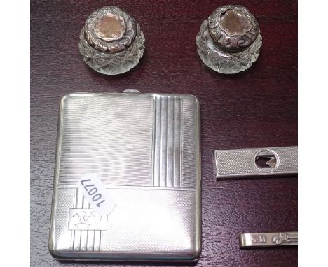 An Art Deco engine turned silver cigarette box, a silver cigar cutter, a tie pin, and 2 silver-topped scent bottles 