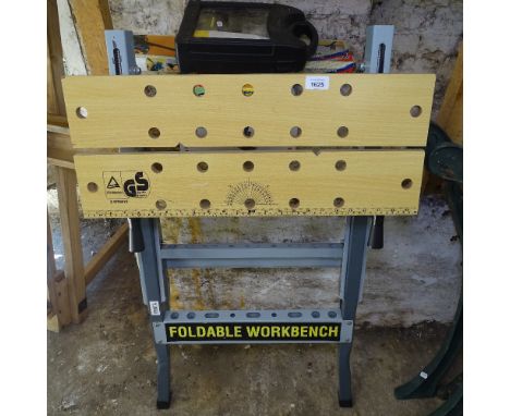 A workbench, and a collection of boxed tools 