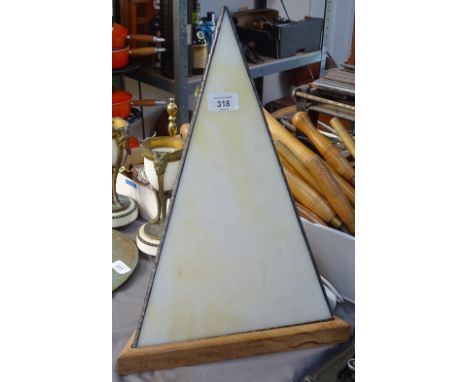 A leaded light triangular table lamp on wooden plinth, height 45cm 