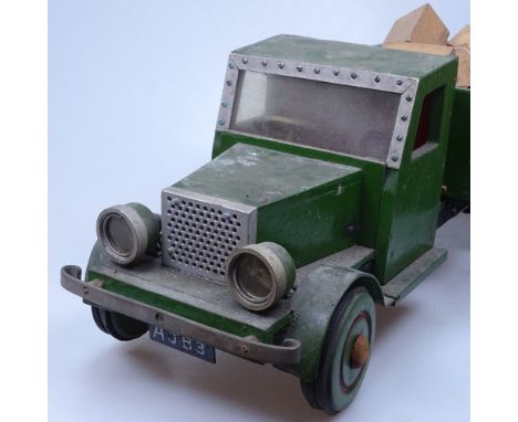 A Vintage painted wood toy tipper-truck with a load of bricks, length 47cm 