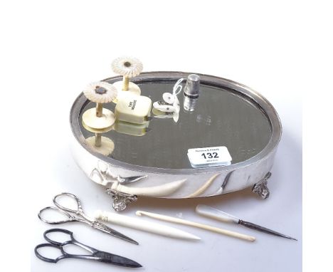 An oval mirrored stand, 20.5cm, bone and mother-of-pearl cotton reels, scissors etc 